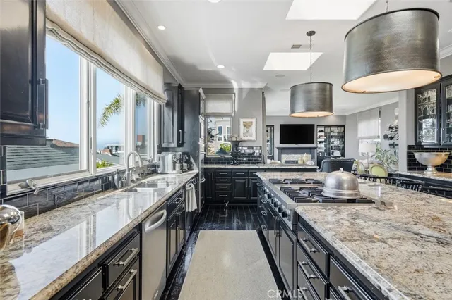a kitchen with stainless steel appliances granite countertop a sink stove and cabinets