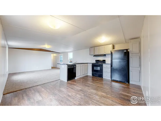 a kitchen with a refrigerator and a sink