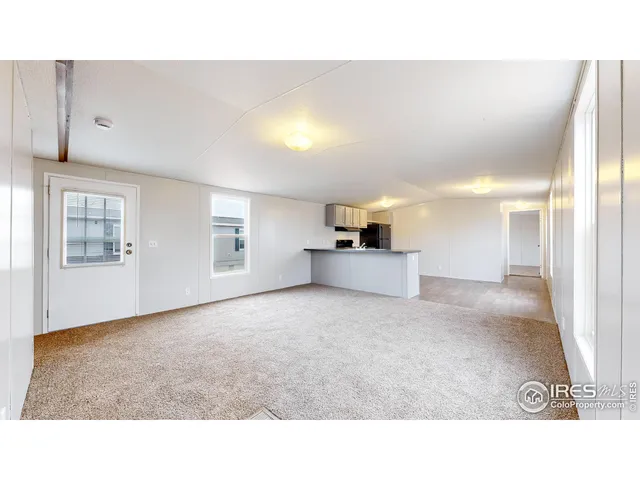 a open hall with wooden floor and windows