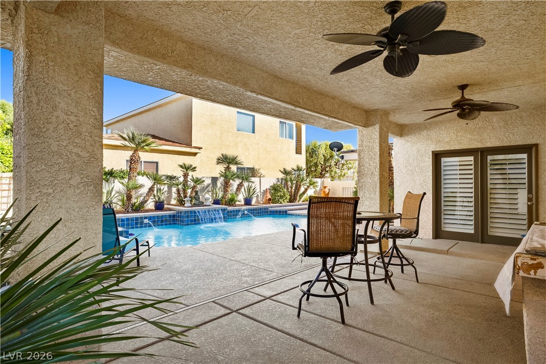 1135 Calico Ridge Drive Henderson, NV 89011 - Photo 47 of 86 A private covered patio provides a shaded oasis overlooking a tranquil pool with multiple water features.