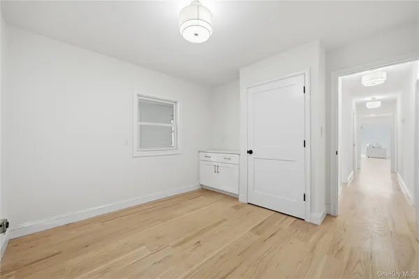 a view of a room with wooden floor and white walls