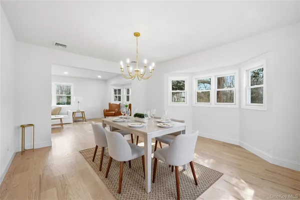 a view of a dining room with furniture and chandelier