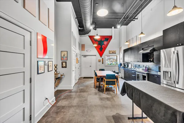 a kitchen with stainless steel appliances granite countertop a sink a stove and refrigerator
