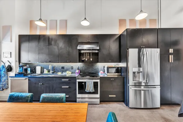 a kitchen with a table chairs stove and cabinets