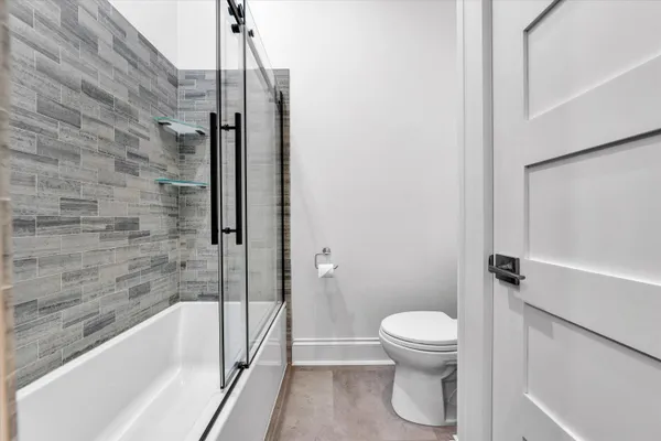 a bathroom with a shower and a toilet