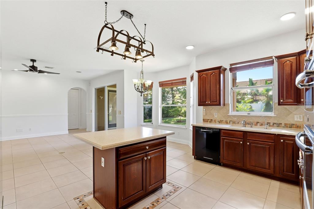 93 Braelock Drive Ocoee, FL 34761 - Photo 11 of 58 a kitchen with stainless steel appliances granite countertop a sink and stove