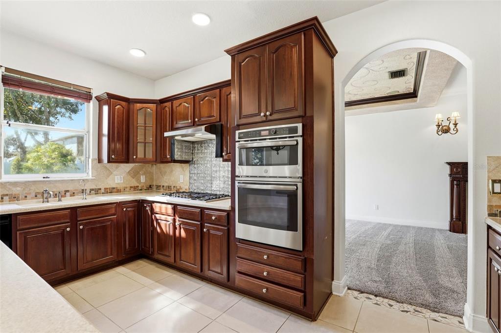 93 Braelock Drive Ocoee, FL 34761 - Photo 15 of 58 a kitchen with stainless steel appliances granite countertop a refrigerator and a sink
