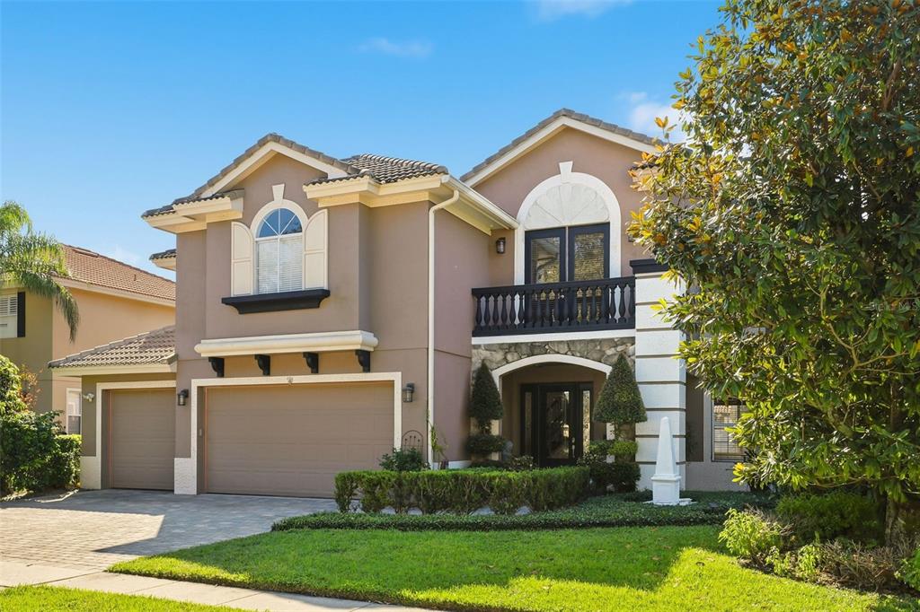 93 Braelock Drive Ocoee, FL 34761 - Photo 2 of 58 a front view of a house with garden