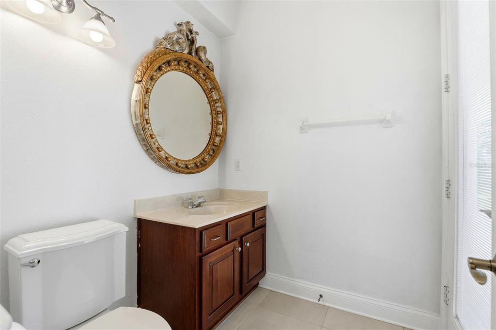 93 Braelock Drive Ocoee, FL 34761 - Photo 21 of 58 a bathroom with a toilet sink vanity and mirror