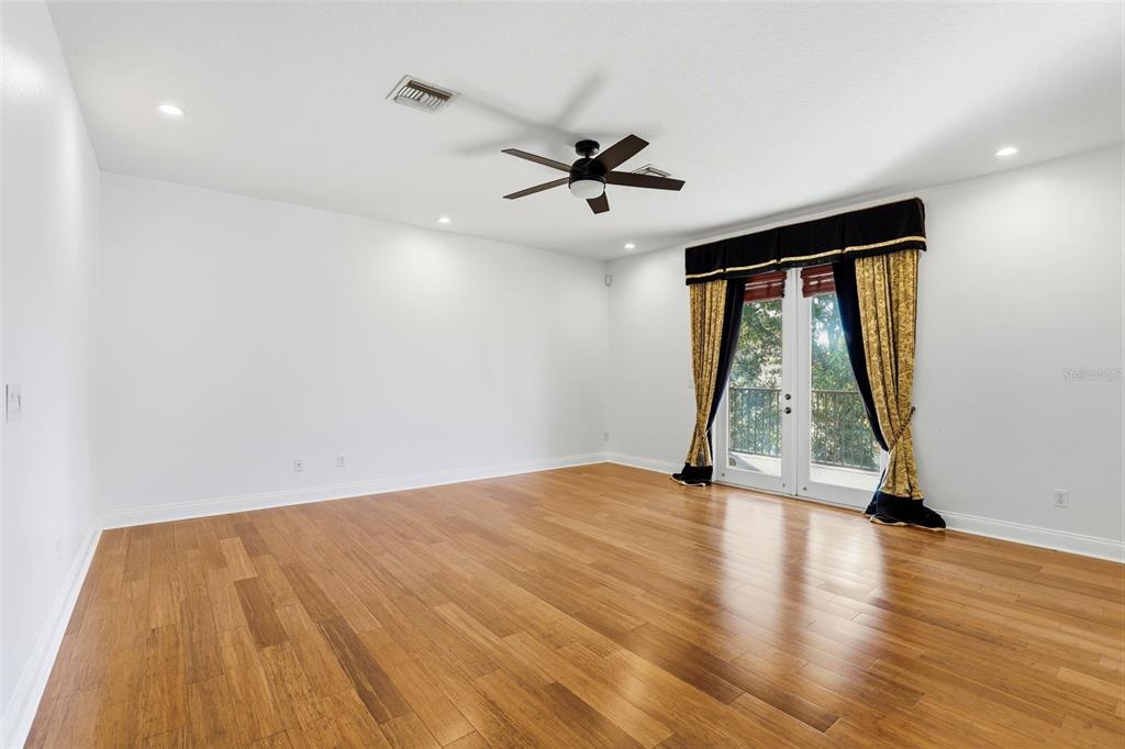 93 Braelock Drive Ocoee, FL 34761 - Photo 23 of 58 a view of empty room with wooden floor and fan
