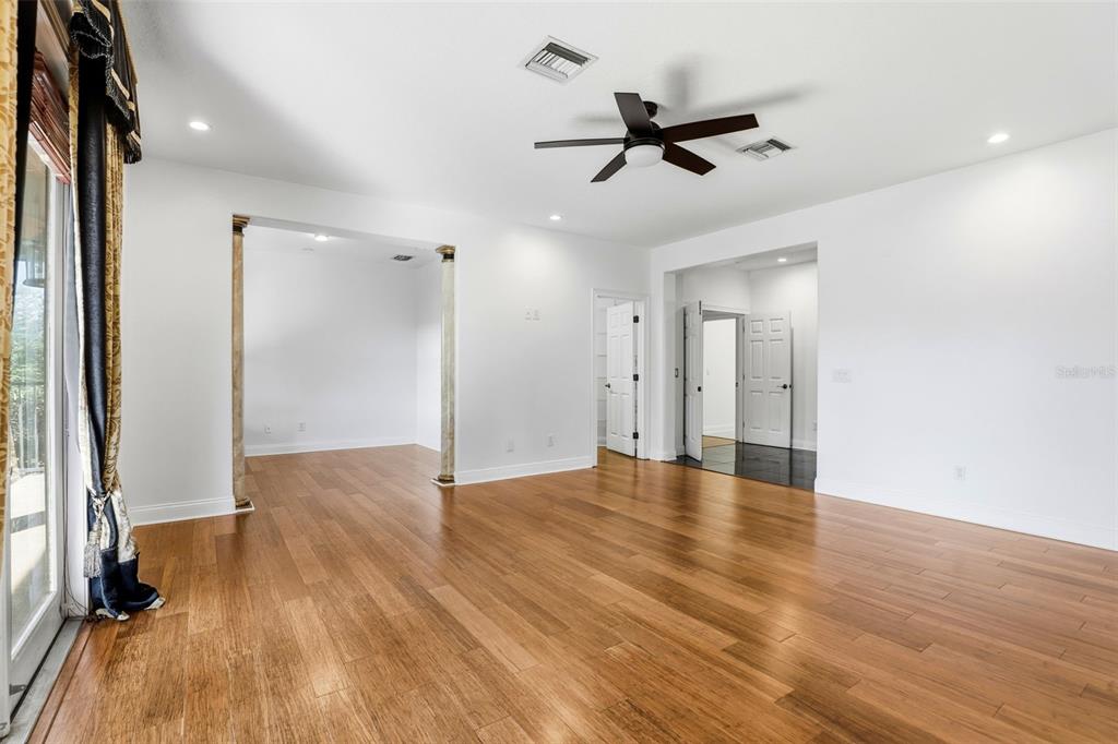 93 Braelock Drive Ocoee, FL 34761 - Photo 24 of 58 a view of empty room with wooden floor and fan