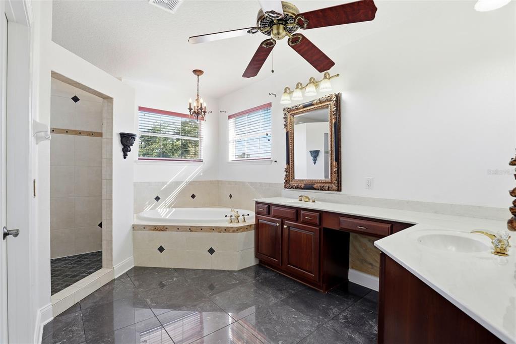 93 Braelock Drive Ocoee, FL 34761 - Photo 26 of 58 a bathroom with a tub sink and mirror