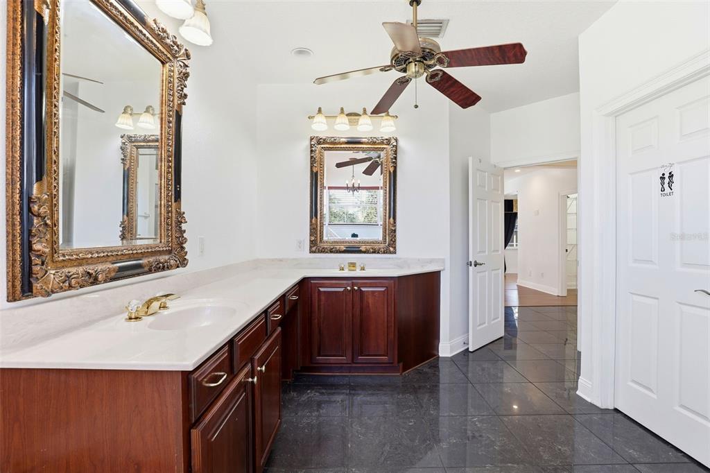 93 Braelock Drive Ocoee, FL 34761 - Photo 27 of 58 a bathroom with a sink a vanity and a mirror