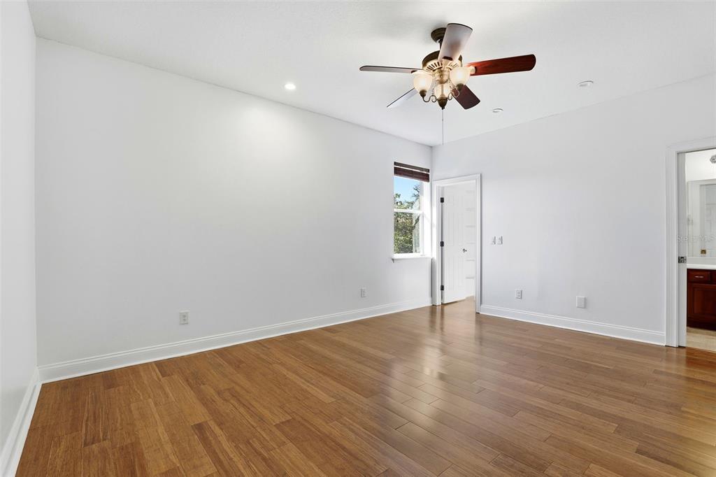 93 Braelock Drive Ocoee, FL 34761 - Photo 34 of 58 an empty room with wooden floor ceiling fan and window