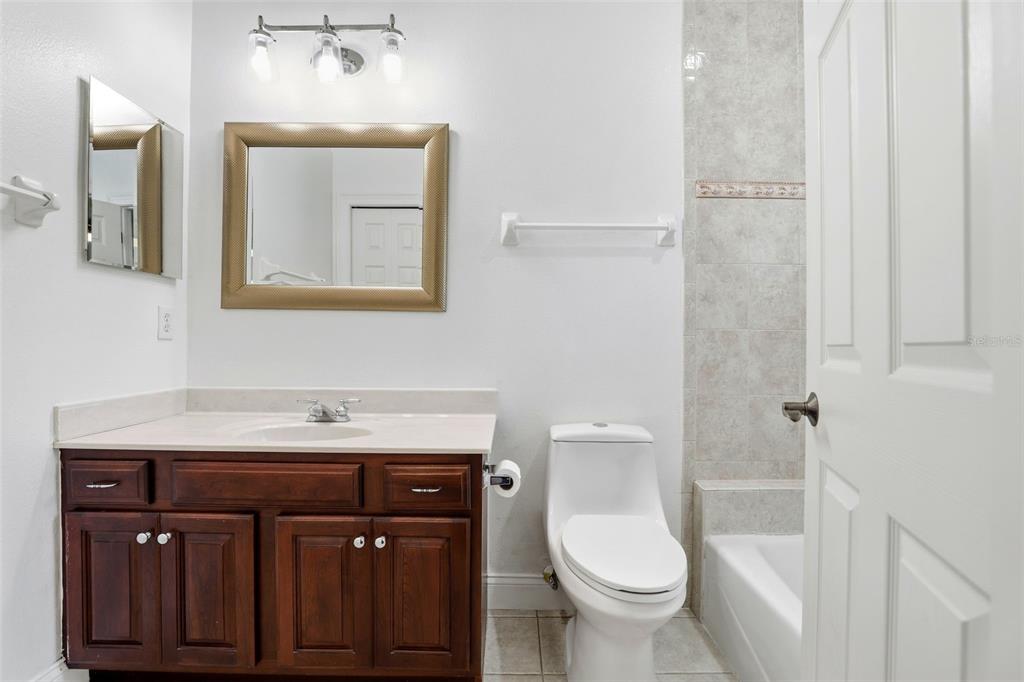 93 Braelock Drive Ocoee, FL 34761 - Photo 42 of 58 a bathroom with a toilet a sink and mirror
