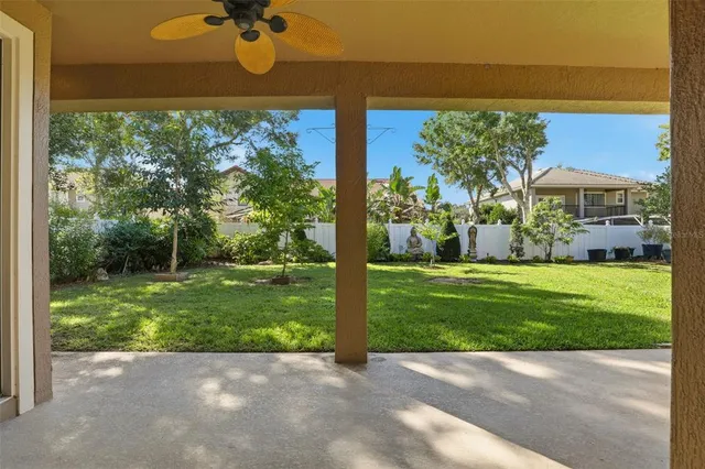 a view of a backyard with table and chairs and potted plants