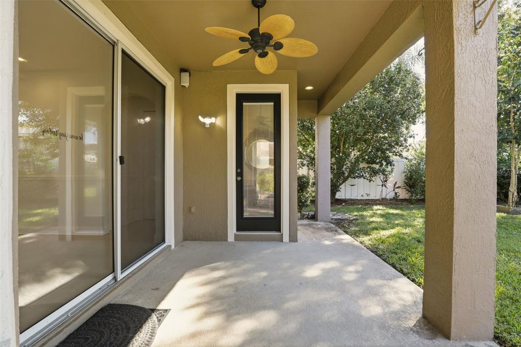 93 Braelock Drive Ocoee, FL 34761 - Photo 48 of 58 a view of a porch with a floor to ceiling window and a yard