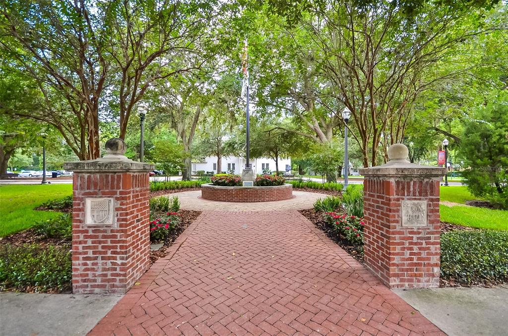 93 Braelock Drive Ocoee, FL 34761 - Photo 56 of 58 a street view with a garden