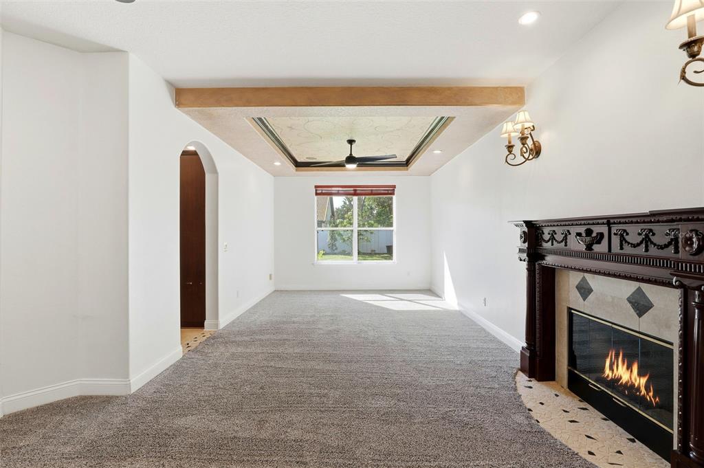93 Braelock Drive Ocoee, FL 34761 - Photo 6 of 58 a view of an empty room with wooden floor fireplace and a window