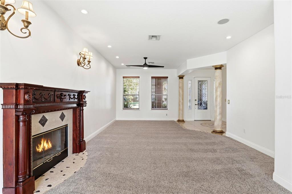 93 Braelock Drive Ocoee, FL 34761 - Photo 9 of 58 a view of an empty room with a fireplace