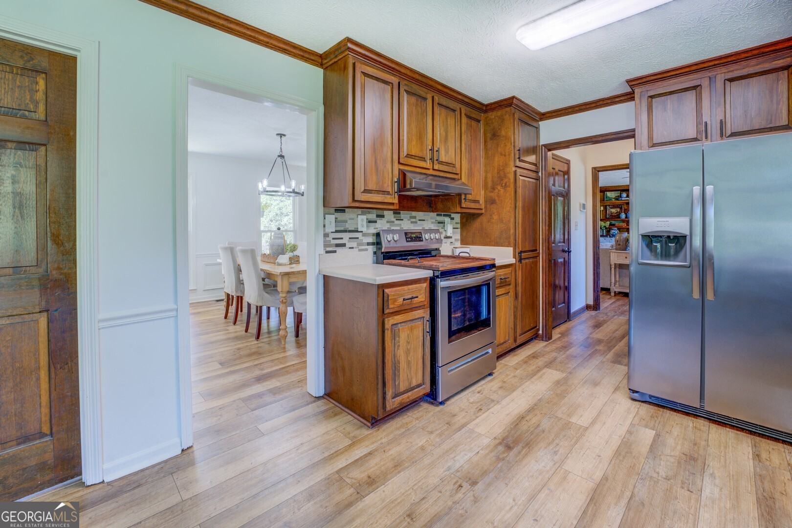 369 Parker Road McDonough, GA 30252 - Photo 13 of 19 a kitchen with stainless steel appliances granite countertop a stove refrigerator and a sink