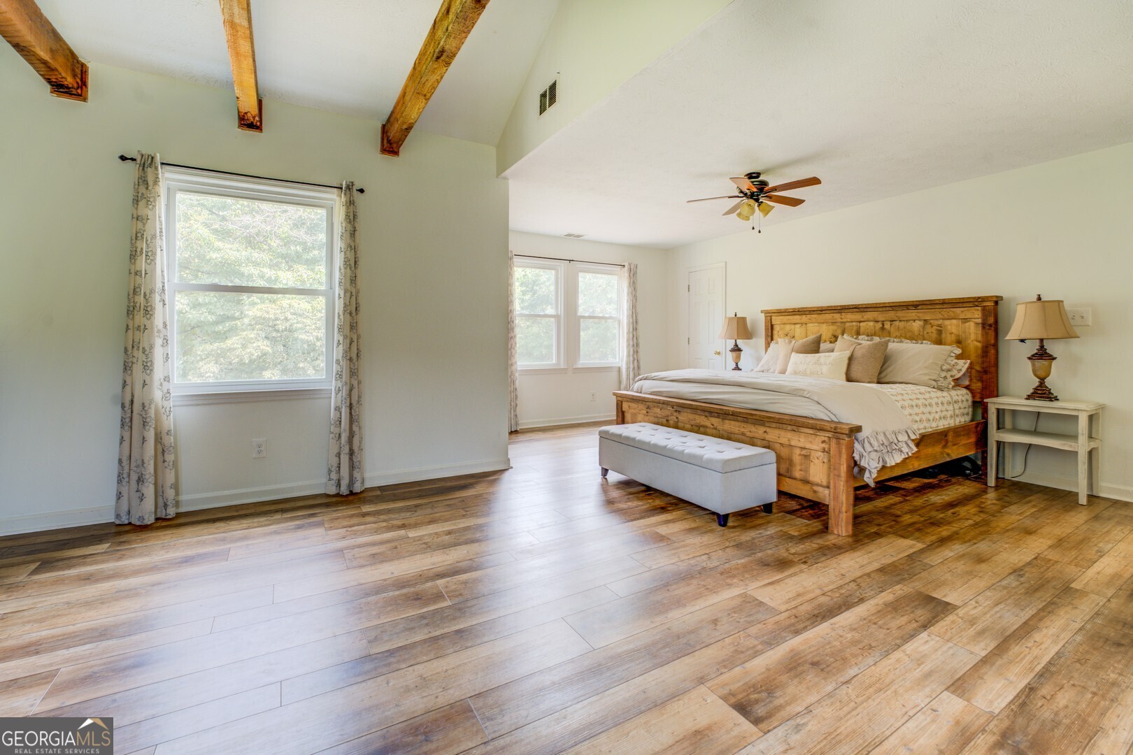 369 Parker Road McDonough, GA 30252 - Photo 9 of 19 a spacious bedroom with a bed and wooden floor