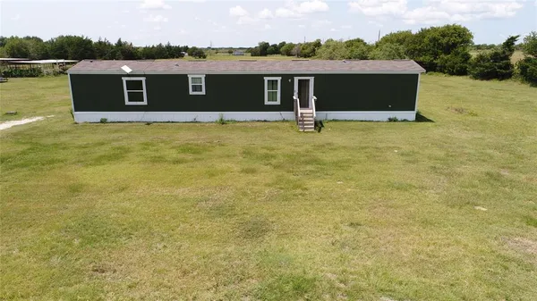 a view of house with yard