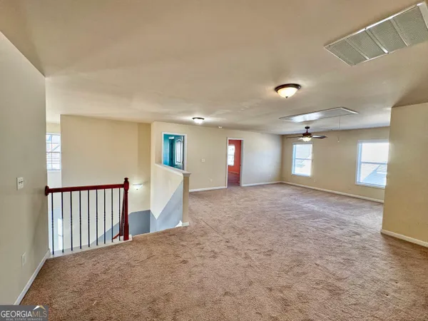 a view of a big room with windows and entryway