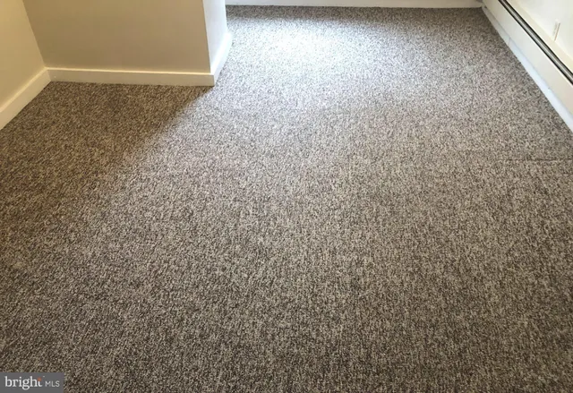 a bathroom with a bathtub shower and toilet