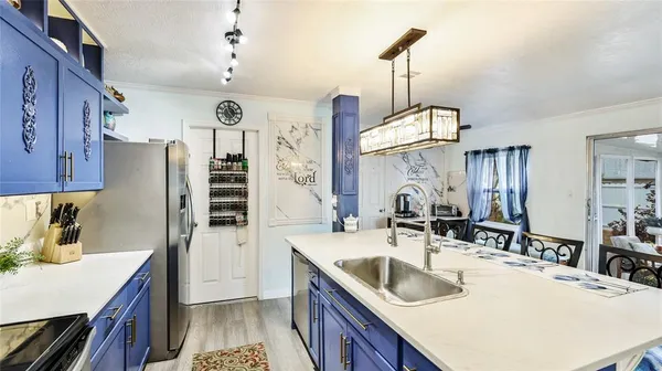 a kitchen with a sink stove and refrigerator