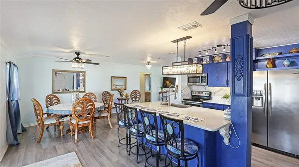 a view of a dining room with furniture kitchen and wooden floor