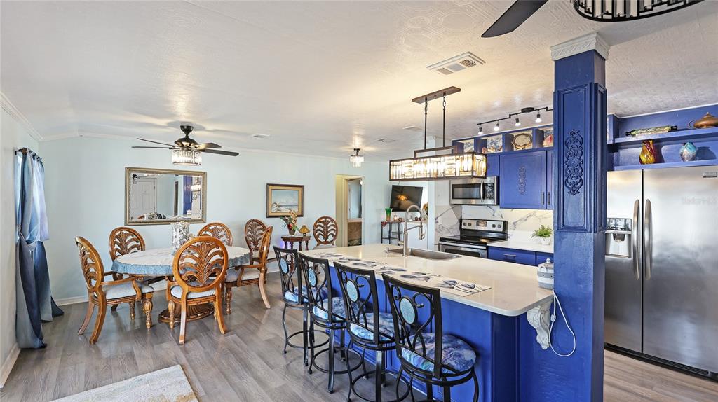 13492 Dibella Avenue Port Charlotte, FL 33981 - Photo 14 of 37 a view of a dining room with furniture kitchen and wooden floor