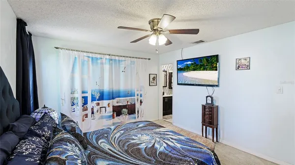 a bedroom with a bed furniture and a flat screen tv