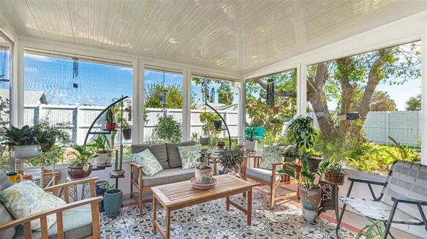 a living room filled with furniture and a potted plant
