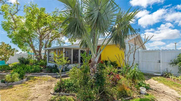 a view of a garden with a house