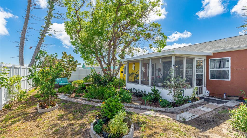 13492 Dibella Avenue Port Charlotte, FL 33981 - Photo 32 of 37 a front view of a house with garden