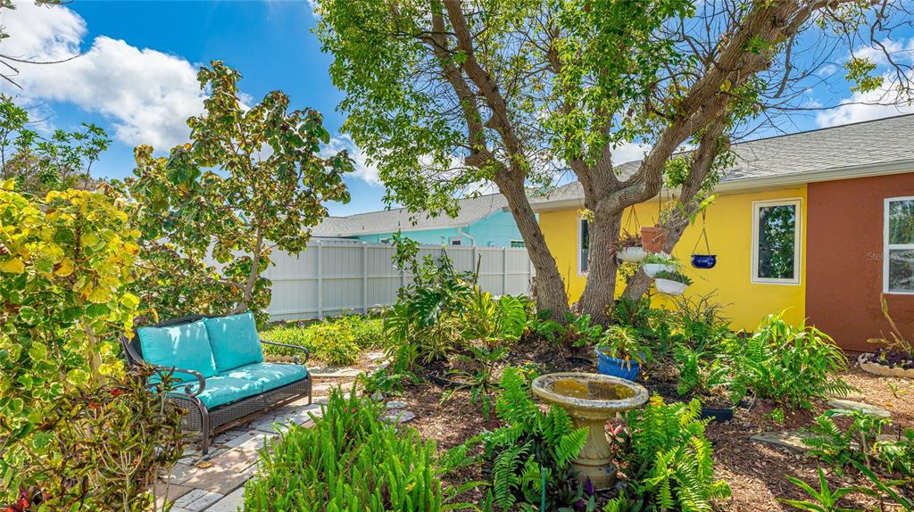 13492 Dibella Avenue Port Charlotte, FL 33981 - Photo 34 of 37 a view of a garden with chairs and potted plants