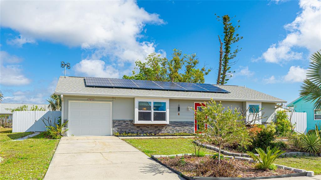 13492 Dibella Avenue Port Charlotte, FL 33981 - Photo 4 of 37 a front view of a house with a garden