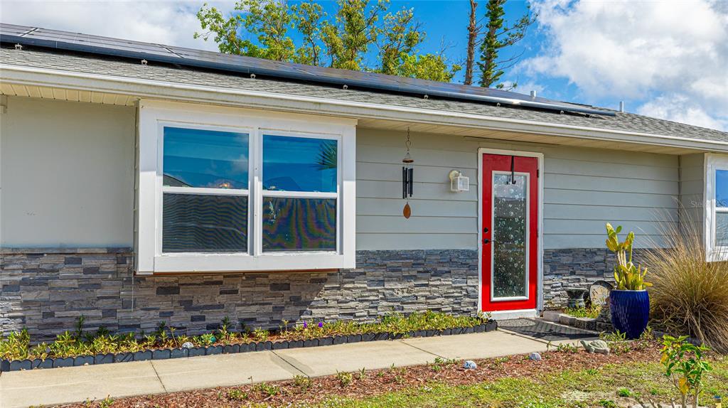 13492 Dibella Avenue Port Charlotte, FL 33981 - Photo 5 of 37 a front view of a house with a yard