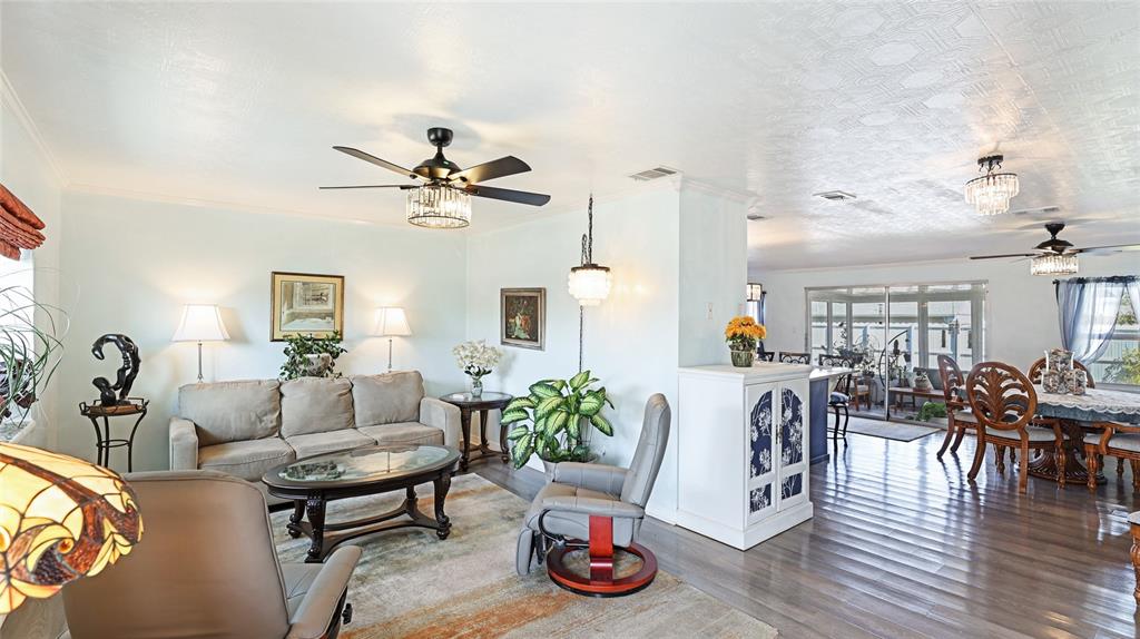13492 Dibella Avenue Port Charlotte, FL 33981 - Photo 7 of 37 a living room with furniture and wooden floor