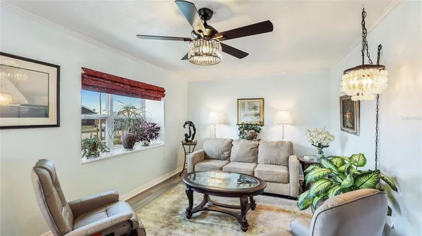 a living room with furniture a window and a chandelier
