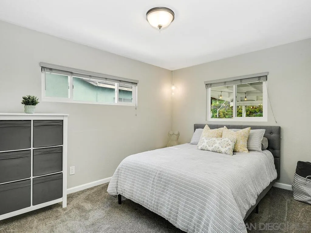 4427 68th Street La Mesa, CA 91942 - Photo 19 of 33 a bedroom with a bed and a window