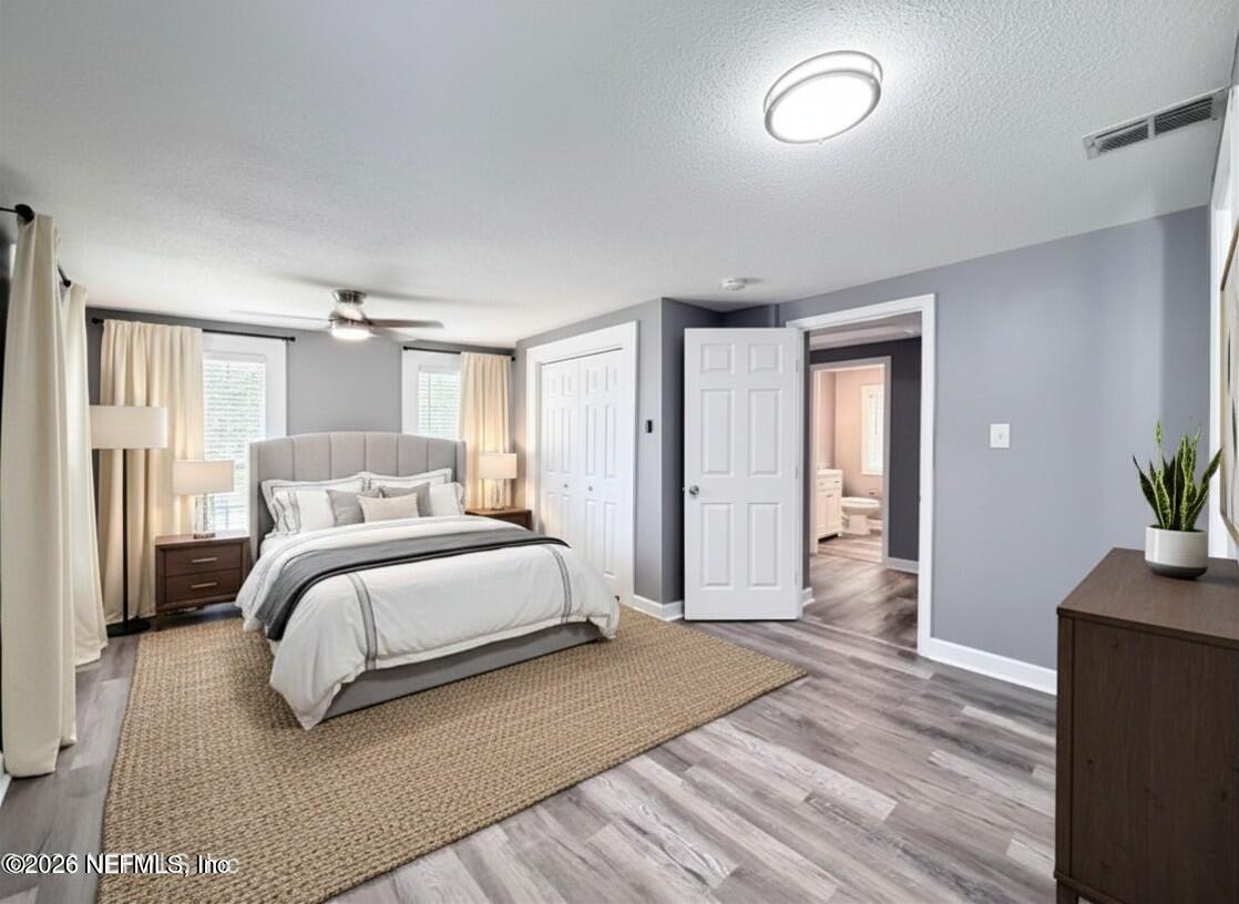 5336 Cruz Road Jacksonville, FL 32207 - Photo 22 of 29 a spacious bedroom with a bed and a potted plant
