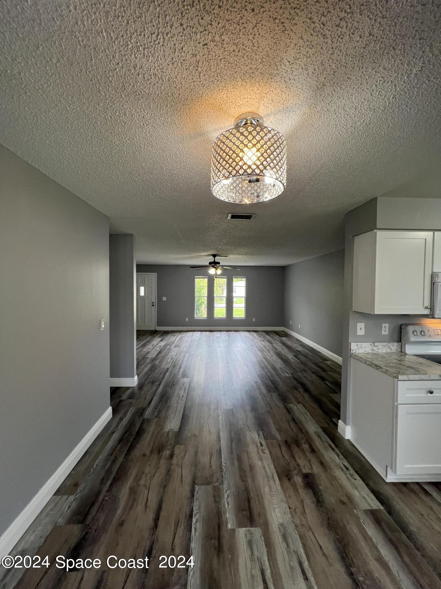 219 Capron Road Cocoa, FL 32927 - Photo 12 of 21 wooden floor in an empty room with a window