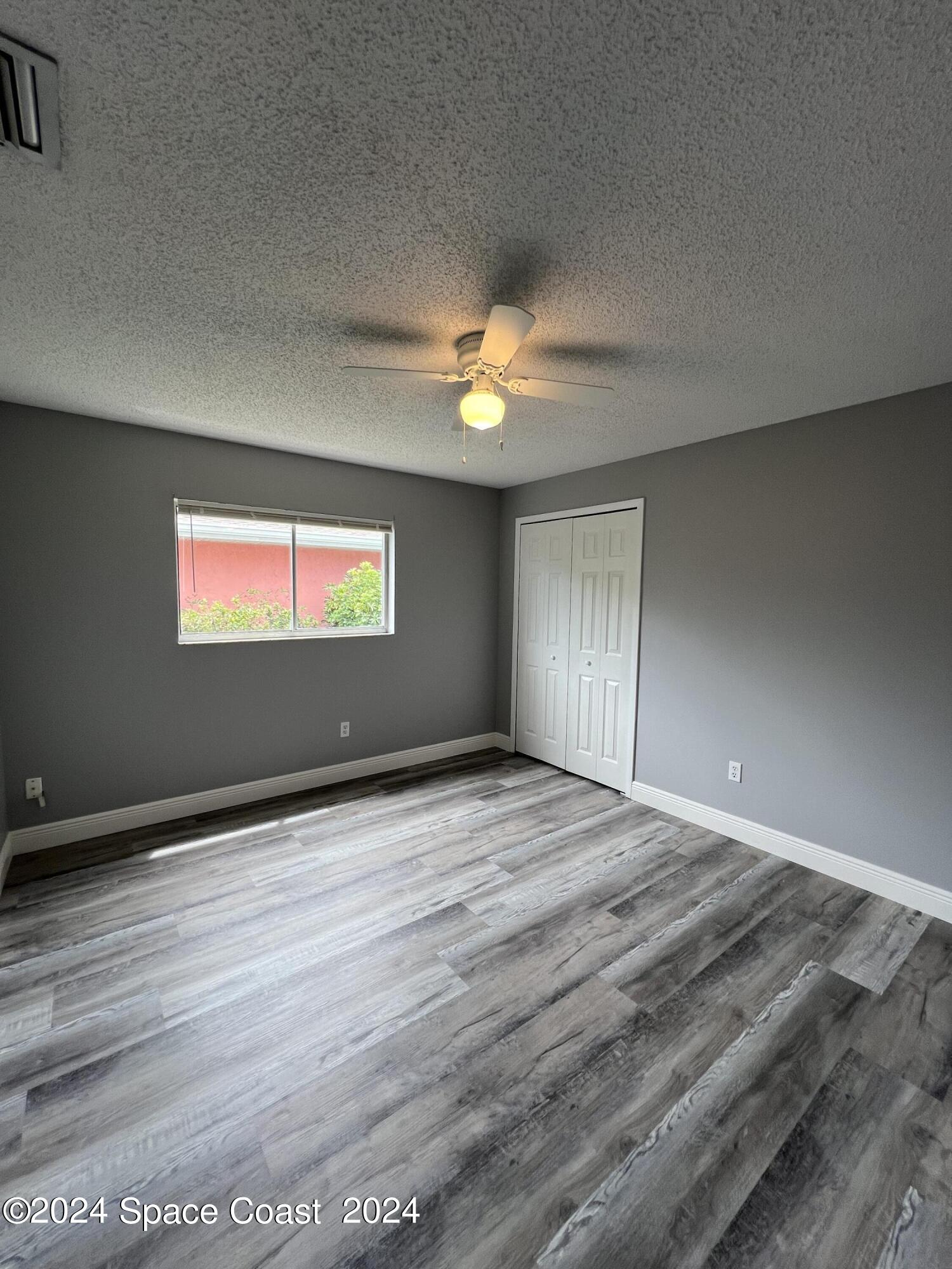 219 Capron Road Cocoa, FL 32927 - Photo 16 of 21 a view of an empty room and window and a ceiling fan