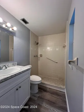 a bathroom with a toilet and a shower