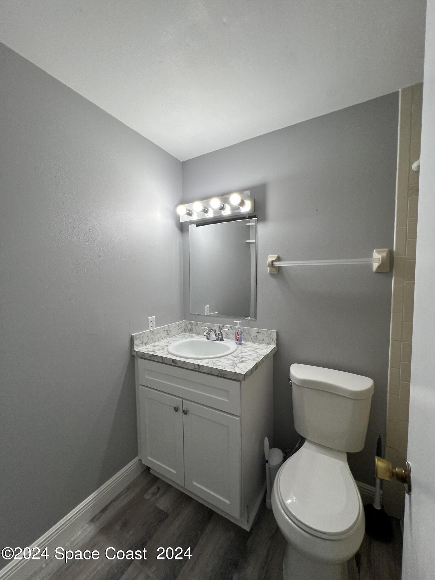 219 Capron Road Cocoa, FL 32927 - Photo 20 of 21 a bathroom with a toilet a sink and mirror