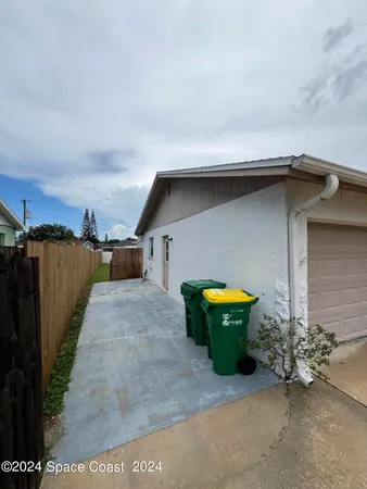 a small pool with a bench in front of house