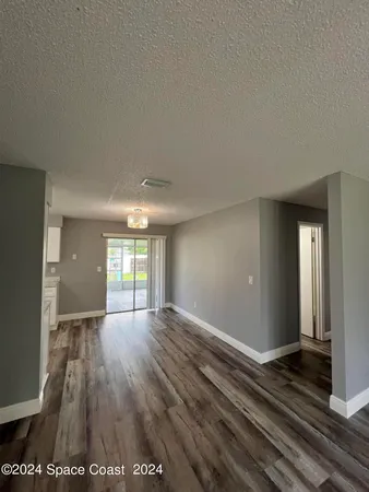 a view of a room with window and chandelier
