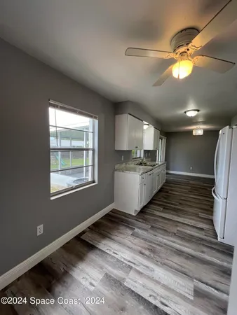 a kitchen with counter top a sink and appliances
